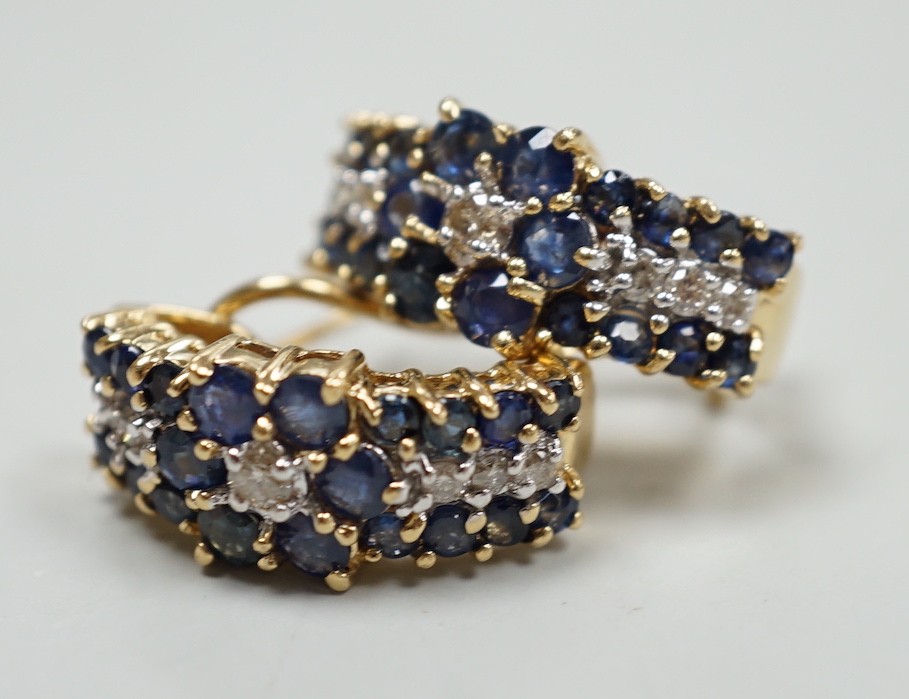 A modern pair of 14k yellow metal, sapphire and diamond cluster set demi-lune earrings, 19mm, gross weight 7.4 grams.
